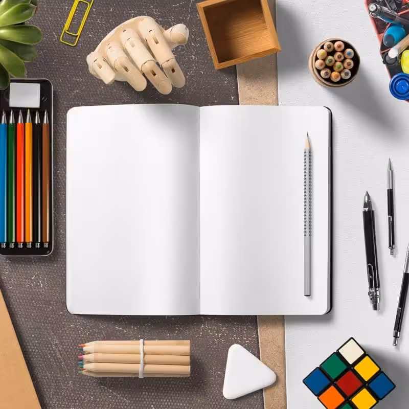 Colorful stationery and office supplies on a workspace for creative and professional design projects.