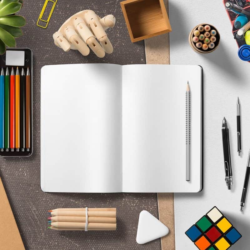Colorful stationery and office supplies on a workspace for creative and professional design projects.