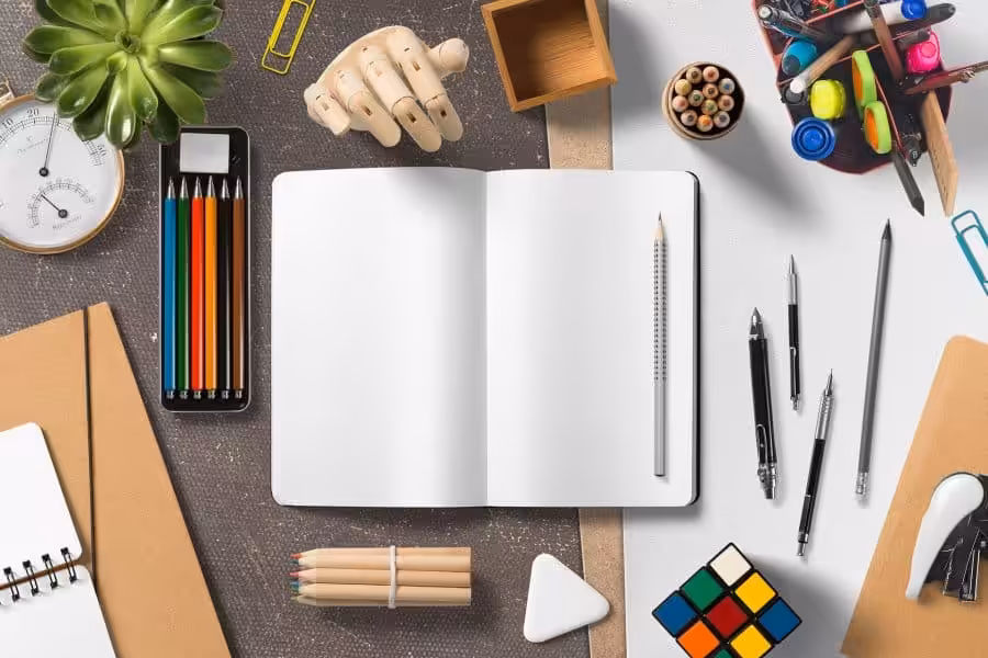 Colorful stationery and office supplies on a workspace for creative and professional design projects.